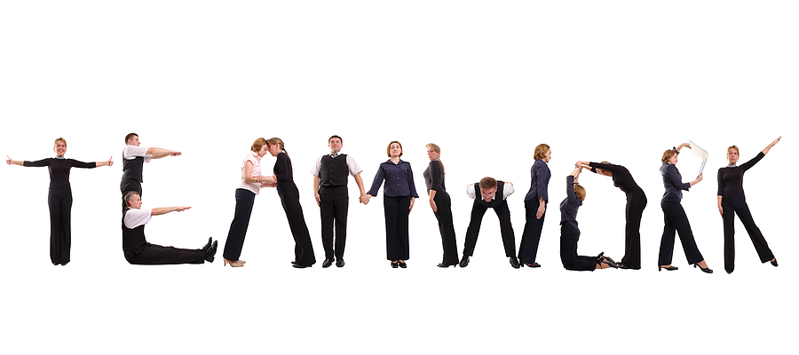 Group of young business people standing over white to form teamwork word